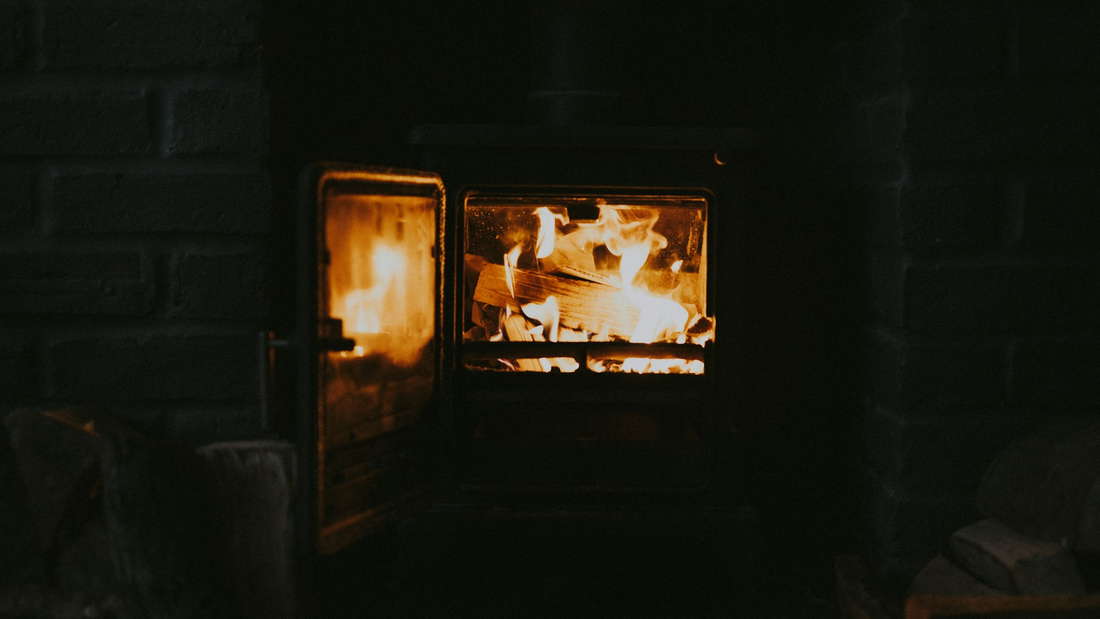 Log burner glowing in a dark room