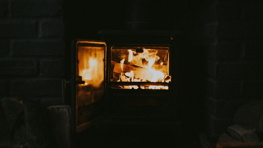 Log burner glowing in a dark room